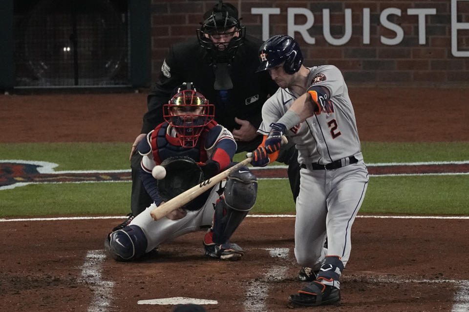 Houston Astros' Alex Bregman hits a RBI-double during the second inning in Game 5 of baseball's World Series between the Houston Astros and the Atlanta Braves Sunday, Oct. 31, 2021, in Atlanta. (AP Photo/John Bazemore)