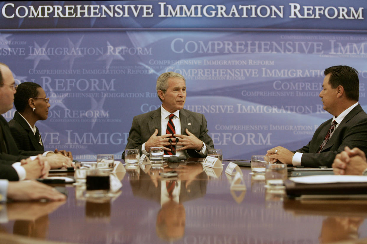 FILE - President George W. Bush, center, makes a statement to reporters regarding the verification of an employee's immigration status during a meeting at a hotel in Washington, May 16, 2007. From left, Ron Cromwell, district manager of TITAN Staffing Services; Glenda Wooten-Ingram, human resources director of Embassy Suites Washington DC-Convention Center; and James Burch, Vice President of Charter Commercial Drywall. (AP Photo/Charles Dharapak, File)