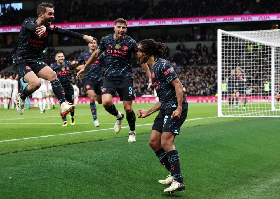 Manchester City players celebrate after Nathan Ake, right, scores their winning goal (Reuters)