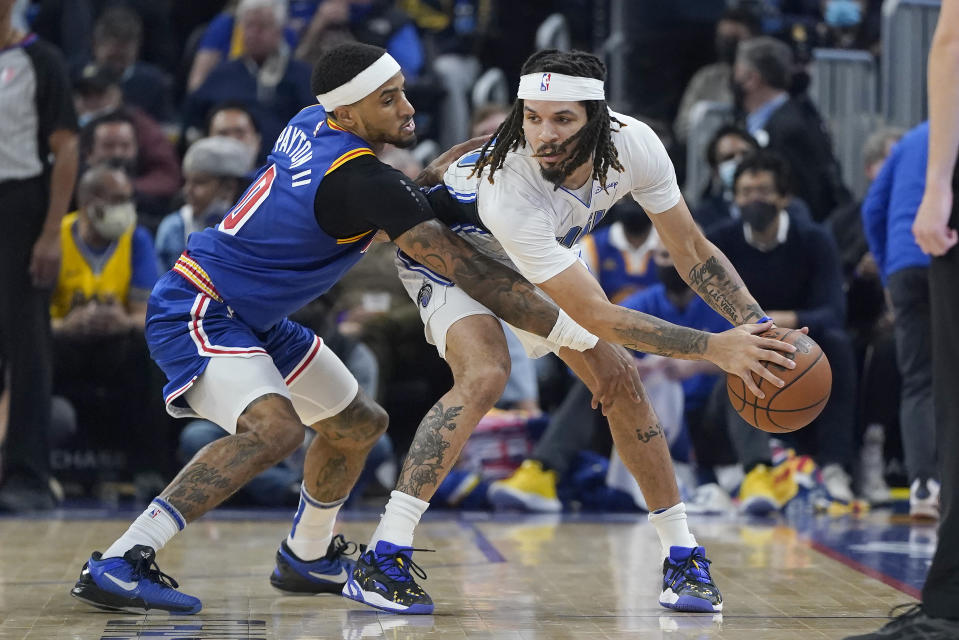 Orlando Magic guard Cole Anthony, right, is defended by Golden State Warriors guard Gary Payton II during the first half of an NBA basketball game in San Francisco, Monday, Dec. 6, 2021. (AP Photo/Jeff Chiu)