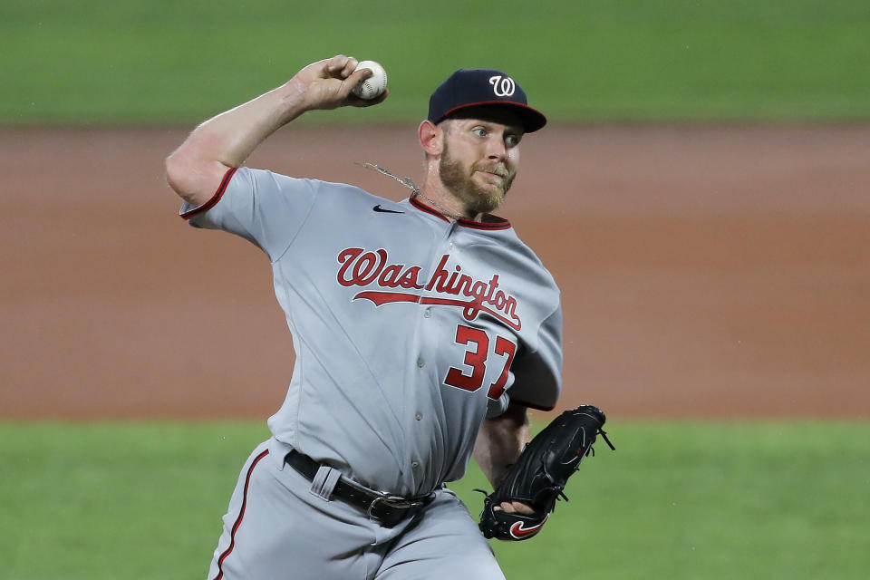 Washington Nationals starting pitcher Stephen Strasburg throws a pitch to the Baltimore Orioles during the first inning of a baseball game, Friday, Aug. 14, 2020, in Baltimore. (AP Photo/Julio Cortez)