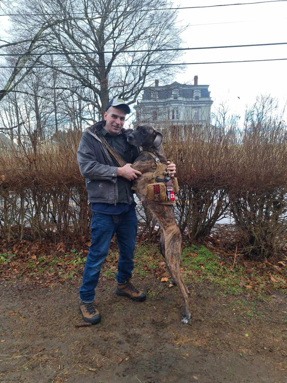 Brookfield town official Christopher Kelleher, who is disabled, with his service dog, Rosie.