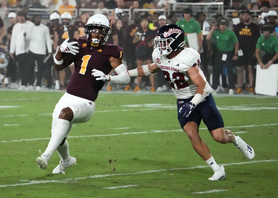 Arizona State Sun Devils wide receiver Xavier Guillory (1) carries the ball against Fresno State Bulldogs defensive back Steven Comstock (22) in the first half at Mountain America Stadium in Tempe on Sept. 16, 2023.