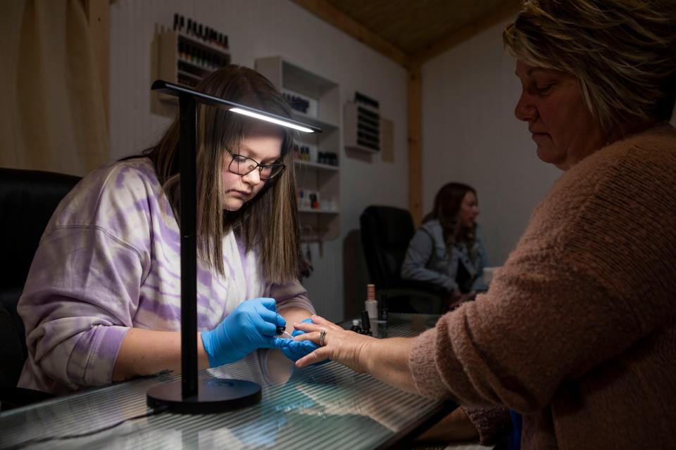 Co-owner Sally Hettinger applies gel to the nails of Her mother Tammy Fee at The Nail Shed on Jan. 20, 2023 in Chillicothe, Ohio.