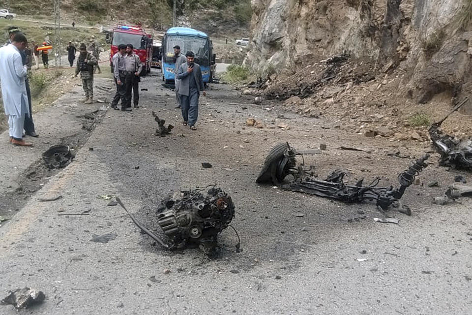 Police officers examine the site of suicide bombing at a highway in Shangla, district in the Pakistan's Khyber Pakhtunkhwa province, Tuesday, March 26, 2024. A suicide bomber in northwest Pakistan has rammed his explosive-laden car into a vehicle on Tuesday, killing five Chinese nationals and their Pakistani driver, police and government officials said. (AP Photo)