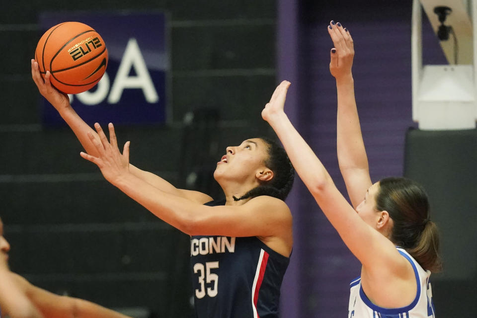 Connecticut guard Azzi Fudd (35) goes to the basket as Duke forward Mia Heide, right, defends during the second half of an NCAA college basketball game in the Phil Knight Legacy tournament Friday, Nov. 25, 2022, in Portland, Ore. (AP Photo/Rick Bowmer)