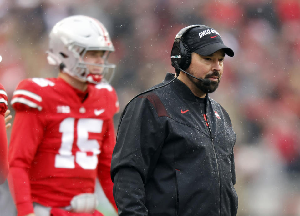 Ohio State coach Ryan Day, right, watches his team in front of Ohio State quarterback Devin Brown during the first half of an NCAA college football game against Indiana Saturday, Nov. 12, 2022 in Columbus, Ohio. (AP Photo/Paul Vernon)