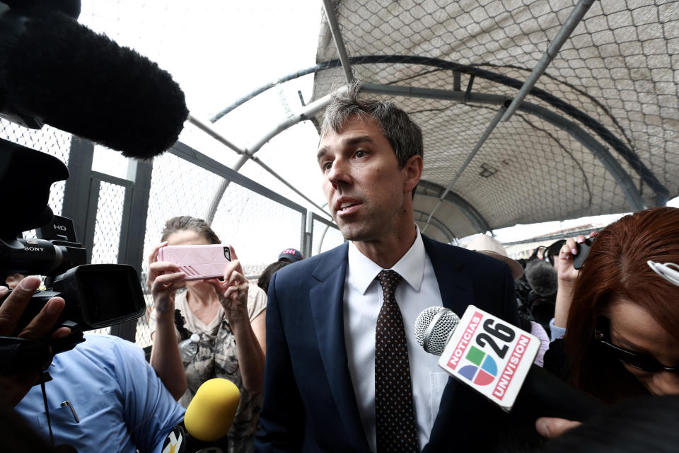 Democratic presidential candidate Beto O'Rourke is surrounded by reporters as he walks on an international bridge to cross into Ciudad Juarez, Mexico, Thursday, Aug. 8, 2019. O’Rourke has crossed the border into Mexico for the funeral of one of the 22 people killed in a mass shooting at a Walmart in El Paso, Texas. (AP Photo/Christian Chavez)