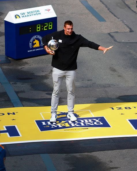 BOSTON, MASSACHUSETTS - APRIL 15: Boston Marathon Grand Marshal and former New England Patriot Rob Gronkowski shows off the winner's trophy at the finish line during the 128th Boston Marathon on April 15, 2024 in Boston, Massachusetts. (Photo by Omar Rawlings/Getty Images)