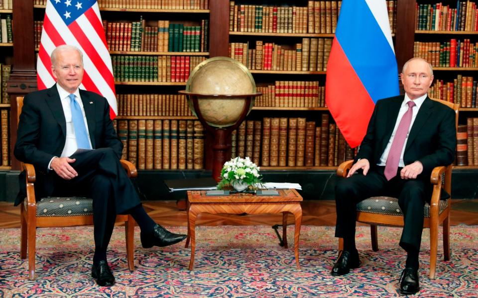 Mr Biden and Mr Putin watch as the press pack is ushered out - Mikhail Metzel/Pool Photo via AP