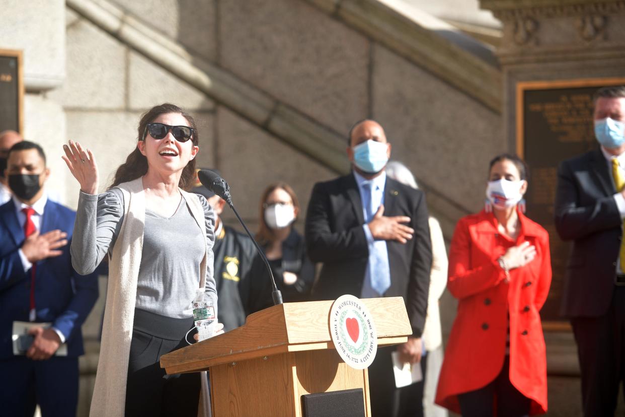 Suellen Diller sings the national anthem outside of city hall April 13, 2021, National Borinqueneers Day. The Borinqueneers refers to the 65th Infantry Regiment, comprised largely of Puerto Rican soldiers.