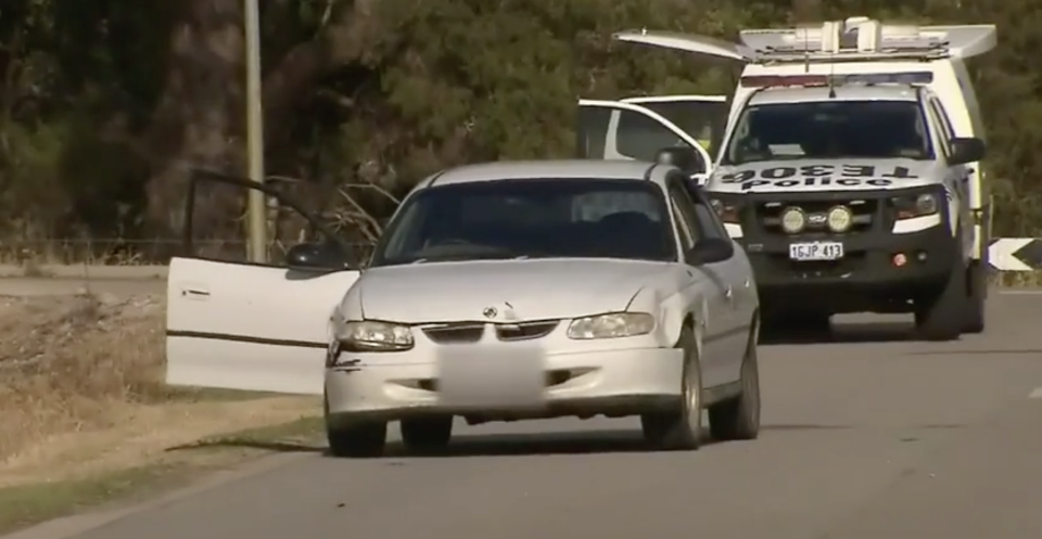 White car in front of a police vehicle after the teen fell from the roof.