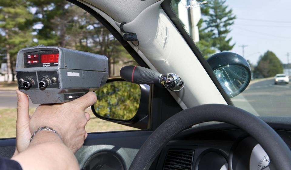 police officer using a handheld radar gun