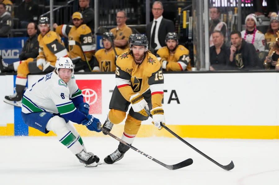 Vegas Golden Knights defenseman <a class="link " href="https://sports.yahoo.com/nhl/players/6747/" data-i13n="sec:content-canvas;subsec:anchor_text;elm:context_link" data-ylk="slk:Noah Hanifin;sec:content-canvas;subsec:anchor_text;elm:context_link;itc:0">Noah Hanifin</a> (15) passes the puck against Vancouver Canucks right wing <a class="link " href="https://sports.yahoo.com/nhl/players/6765/" data-i13n="sec:content-canvas;subsec:anchor_text;elm:context_link" data-ylk="slk:Brock Boeser;sec:content-canvas;subsec:anchor_text;elm:context_link;itc:0">Brock Boeser</a> (6) during the first period of an NHL hockey game Thursday, March 7, 2024, in Las Vegas. (AP Photo/Lucas Peltier)