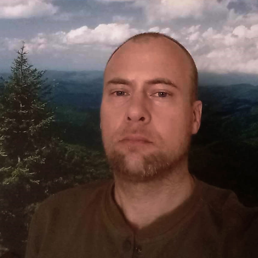 Selfie of U.S. Navy veteran, Travis Zubick, in front of a forest landscape. (Travis Zubick)