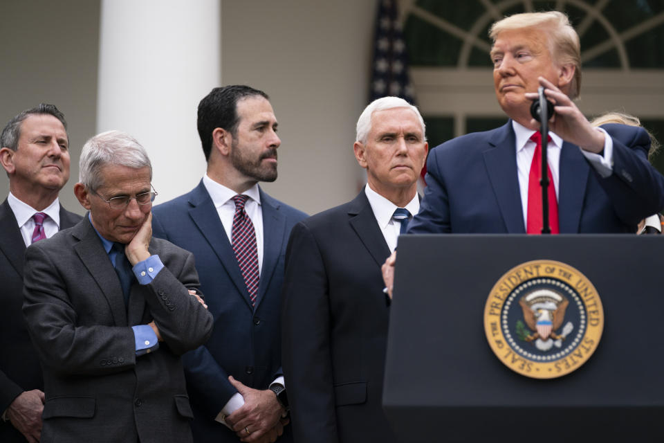 Dr. Anthony Fauci, director of the National Institute of Allergy and Infectious Diseases, listens as President Donald Trump speaks during a news conference on the coronavirus in the Rose Garden at the White House, Friday, March 13, 2020, in Washington. (AP Photo/Evan Vucci)