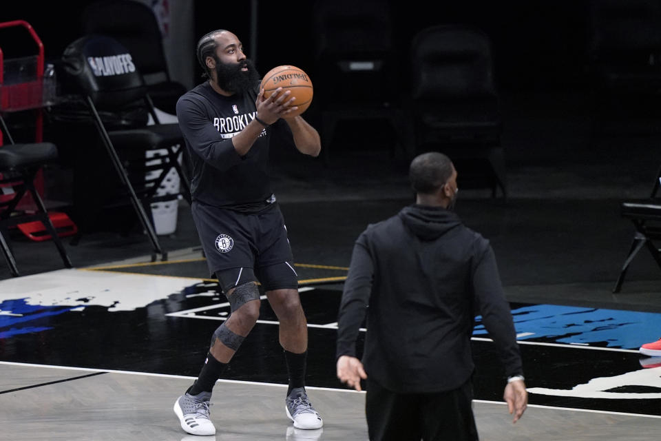 Brooklyn Nets guard James Harden, who has been out with a hamstring injury, warms up on the court before Game 5 of the team's second-round NBA basketball playoff series against the Milwaukee Bucks, Tuesday, June 15, 2021, in New York. (AP Photo/Kathy Willens)