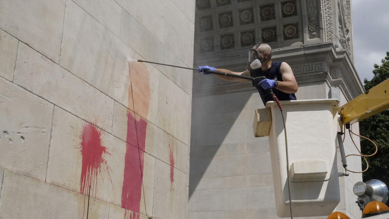 New York City Parks Department workers are seen cleaning the The Washington Square Arch at the park's northern gateway from red paint thrown by vandals using balloons overnight.