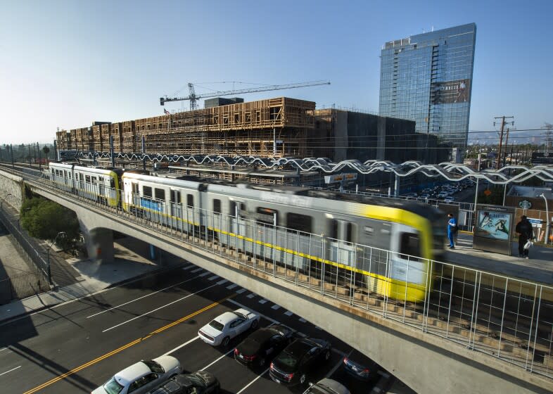 LOS ANGELES, CA - SEPTEMBER 21, 2020: Overall, shows the Cumulus District project, under construction at the intersection of Jefferson and La Cienega boulevards in Los Angeles . In foreground is the Metro Expo Line light rail station. The Cumulus District project consists of a low-rise development, background, left, and a 30-story residential tower, background, right. (Mel Melcon / Los Angeles Times)