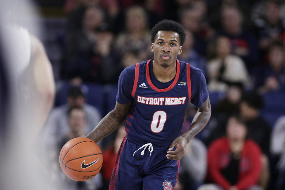 FILE - Detroit Mercy guard Antoine Davis (0) brings the ball up the court during the first half of an NCAA college basketball game against Gonzaga in Spokane, Wash., on Dec. 30, 2019. Davis enters the 2022-23 season as one of the most noteworthy players from mid-major or low-major programs. His 429 career 3-pointers put him just 80 away from the Division I record. (AP Photo/Young Kwak, File)