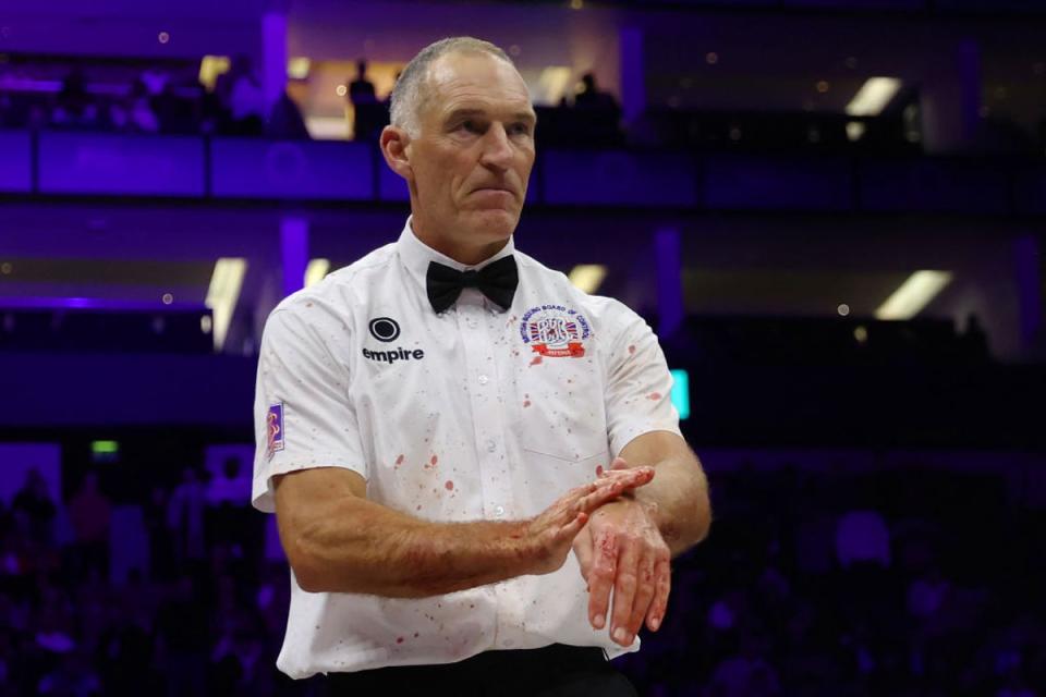 Blood splatters onto the white shirt of the referee, Steve Gray (Getty)