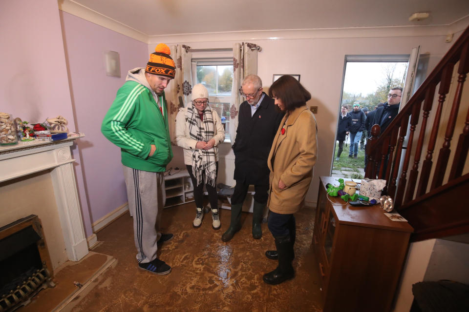 Labour leader Jeremy Corbyn and Labour MP Caroline Flint during a visit to Conisborough, South Yorkshire, meeting residents James and Alison Merritt (left and centre left), in their house which was affected by flooding.