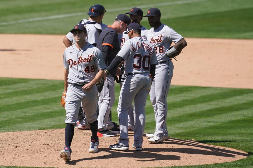 Tigers pitcher Matthew Boyd walks off the mound after being taken out by manager AJ Hinch, center, during the eighth inning of the Tigers' 3-2 loss in Oakland, California, on Sunday, April 18, 2021.