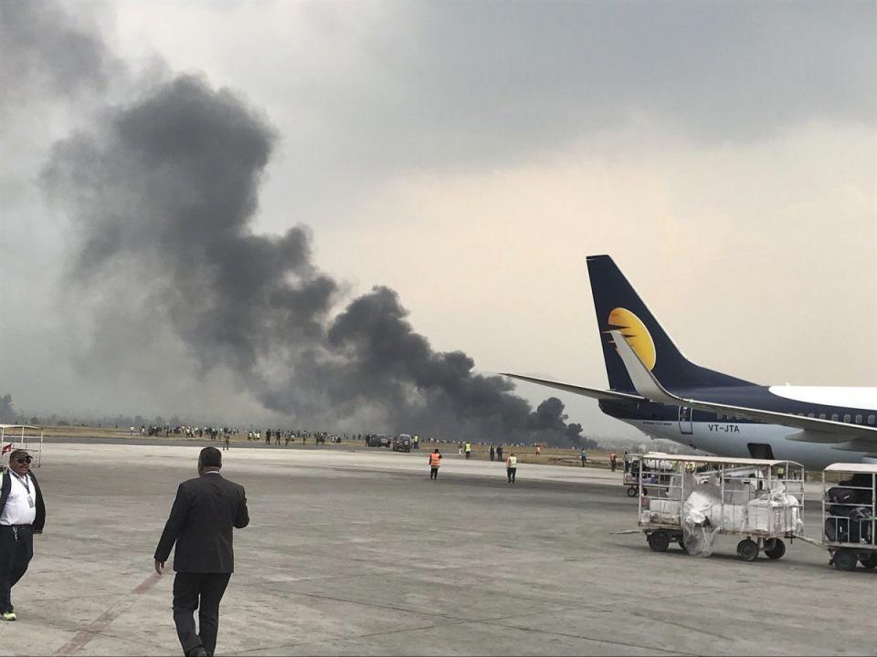 Smoke from the crash site at the airport (Picture: AP)