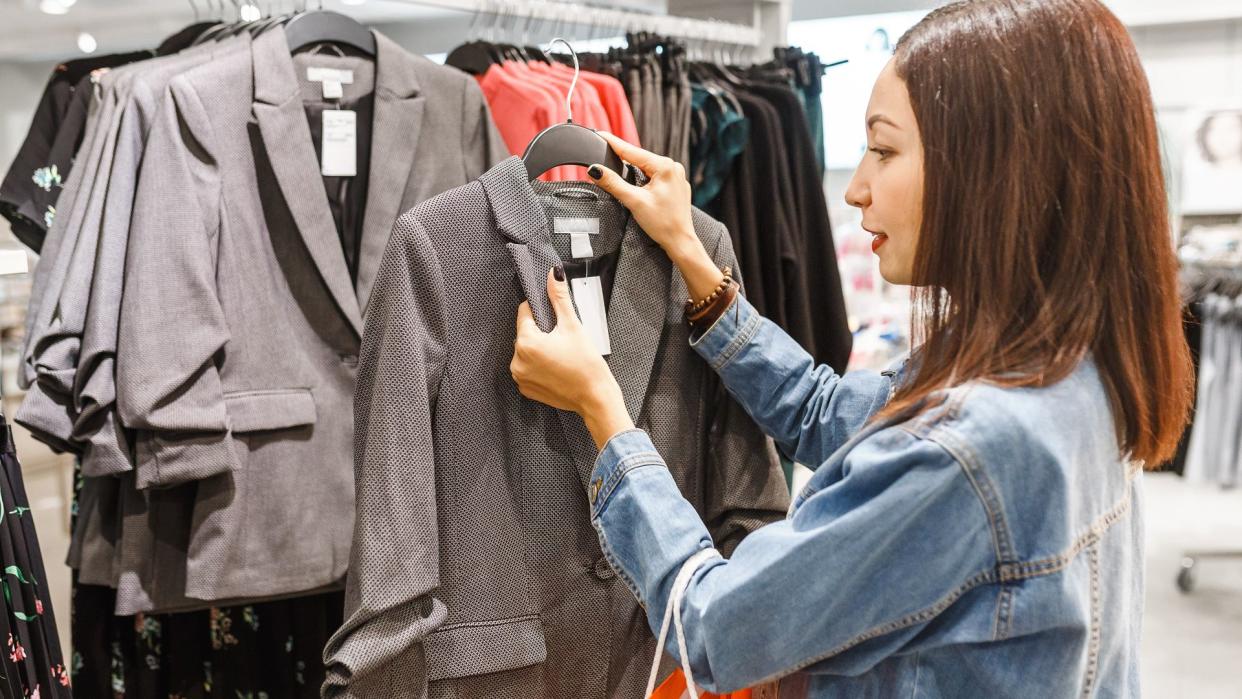 woman checking price on clothing sale