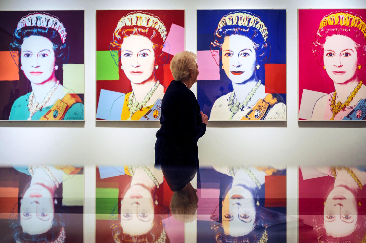 A woman views Queen Elizabeth II by Andy Warhol, 1985, during the press preview of The Queen: Art and Image at the National Portrait Gallery, London on May 16, 2012. (Anthony Devlin / PA Wire file)