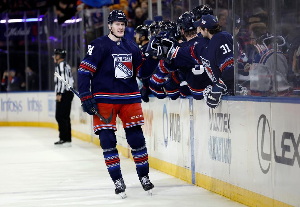 NEW YORK, NEW YORK - DECEMBER 15: Adam Edstrom #84 of the New York Rangers celebrates with the bench after scoring his first NHL goal while making his NHL debut during the third period against the Anaheim Ducks at Madison Square Garden on December 15, 2023 in New York City. The Rangers won 5-1.