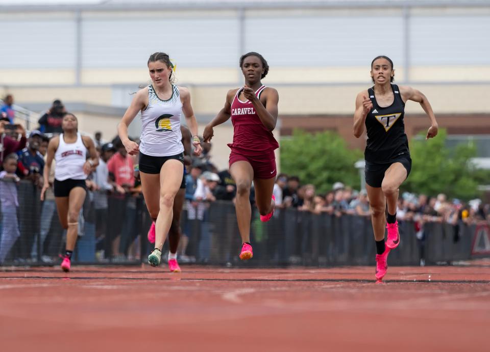 Saint Mark's Reagan Garibaldi, Caravel’s Kennedy Smith and 
Tatnall’s Arianna Montgomery race to the finish line in the Division II girls 200-meter dash at the DIAA Track & Field Championships at Dover High on Saturday, May 20, 2023. Smith won.