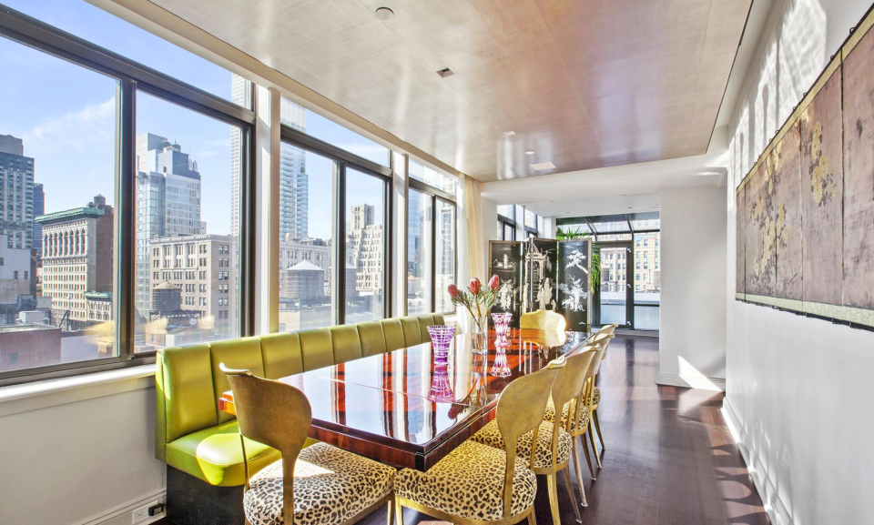 <p>The modern dining room also has plenty of natural light and is centred around a French-deco mahogany table. (Douglas Elliman) </p>