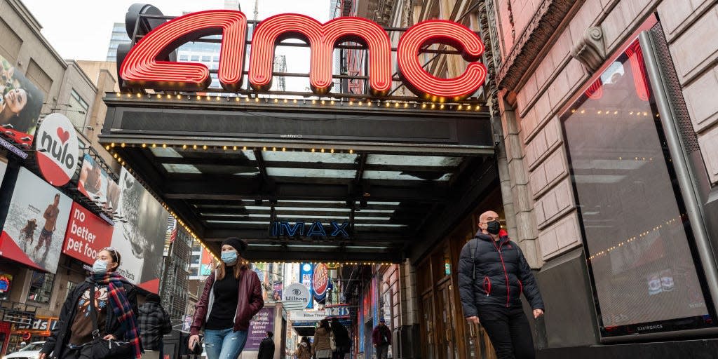 People walk outside the AMC Empire 25 movie theater in Times Square