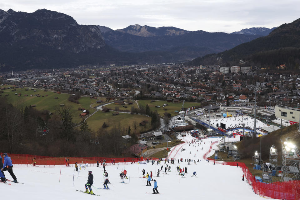 FILE - Athletes inspect the small strip of snow where they will compete in an alpine ski, men's World Cup slalom race, in Garmisch Partenkirchen, Germany, Wednesday, Jan. 4, 2023. Mother Nature and global warming are having just as much say about when and where to hold ski races these days as the International Ski Federation. (AP Photo/Alessandro Trovati, File)