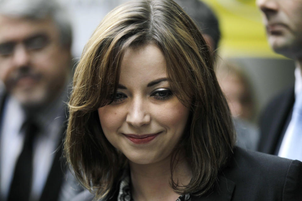 Singer Charlotte Church reacts after speaking to the media outside the High Court in London after hearing the reading of a statement setting out the terms of the settlement for phone hacking damages claim against News International, Monday, Feb. 27, 2012. Church, who testified before a media inquiry of being hounded by Rupert Murdoch's journalists when she was a teen singing sensation, received 600,000 pounds ($951,000) Monday in a phone hacking settlement from News International and said she had been sickened by what she had learnt about intrusion into her private life. (AP Photo/Sang Tan)