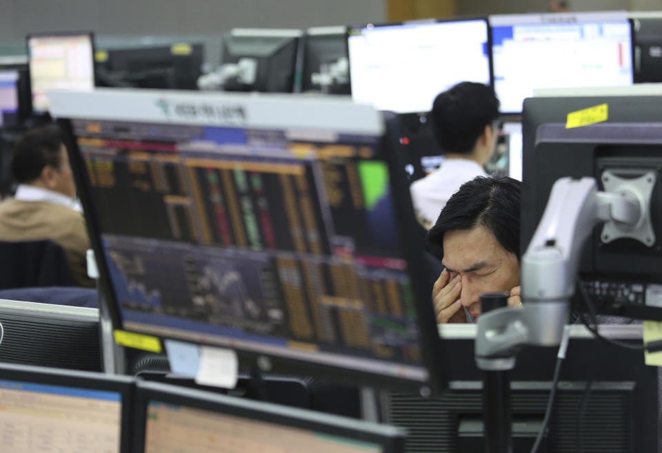 A currency trader talks on the phone at the foreign exchange dealing room of the KEB Hana Bank headquarters in Seoul, South Korea, Thursday, Jan. 10, 2019. Asian markets were mostly lower Thursday as U.S. and Chinese officials wrapped up three days of talks in Beijing without significant breakthroughs. (AP Photo/Ahn Young-joon)