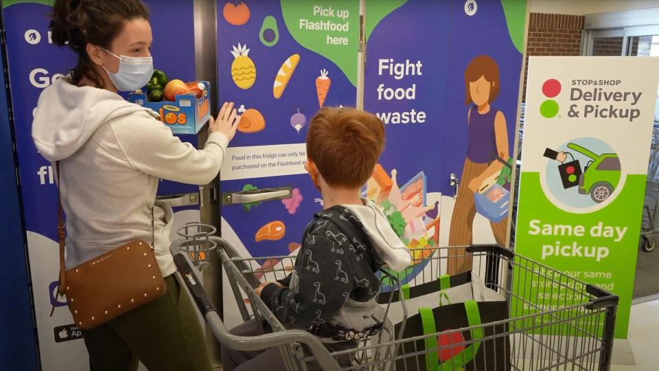 A mother and her son pick up their groceries at the Flashfood Zone at a Stop & Shop store.