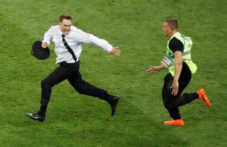 Soccer Football - World Cup - Final - France v Croatia - Luzhniki Stadium, Moscow, Russia - July 15, 2018 Pitch invader Pyotr Verzilov is chased by a steward during the match REUTERS/Christian Hartmann/Files