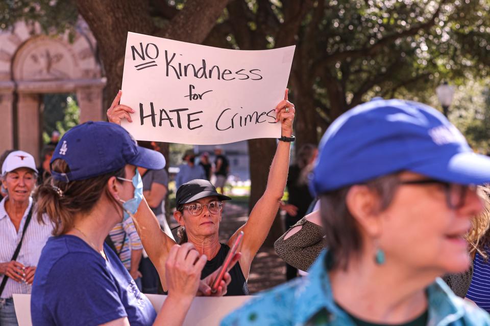 Lauren Lewis holds up a sign at the Rally for Kindness. "I'm all for kindness for people that deserve kindness, but I'm against a rally for kindness when we should be standing up against hate," Lewis said.