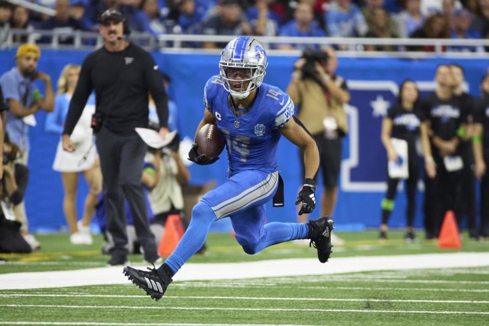 Detroit Lions wide receiver Amon-Ra St. Brown runs the ball against the Atlanta Falcons.