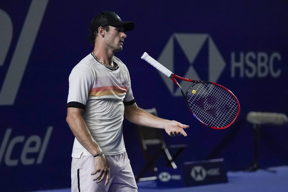 Tommy Paul of the United States tosses his racket after missing a point against Alex de Minaur of Australia in the final match at the Mexican Open tennis tournament in Acapulco, Mexico, Saturday, March 4, 2023. (AP Photo/Eduardo Verdugo)