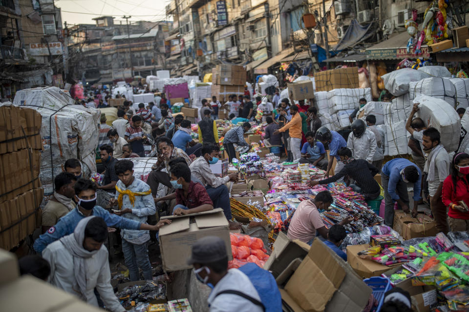 Indians crowd a wholesale market ahead of the Hindu festival of Dussehra in New Delhi, India, Saturday, Oct. 24, 2020. Just weeks after the country of 1.4 billion people fully opened up with a far greater semblance of normality and managed to modestly turn a corner by cutting the new infections by near half, a virus that has killed more than 118,000 Indians and sickened nearly 8 million is expected to return with a renewed surge. The reason: a Hindu festival season that draws tens and thousands of people, packed together shoulder-to-shoulder in temples, shopping districts and congregations, leading to fears and a sense of foreboding among health experts who warn of a whole new cascade of infections, further testing India’s already battered healthcare system. (AP Photo/Altaf Qadri)