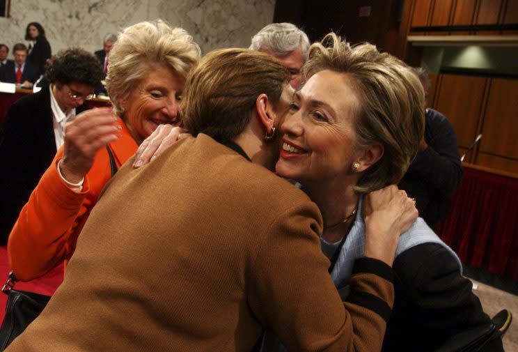 Senator Hillary Clinton hugs Jamie Gorelick, a commission member, during the second public hearing of the 9/11 Commission