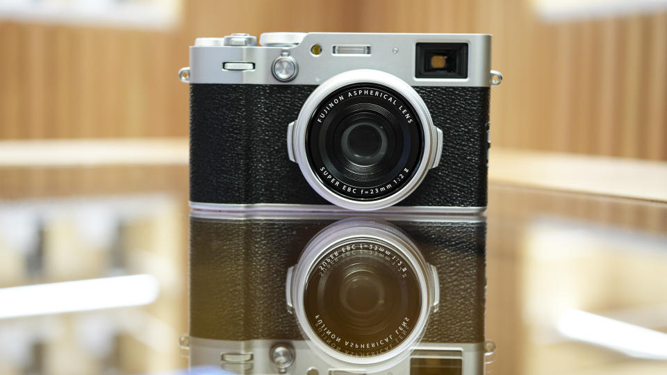 Front of the Fujifilm X100VI reflected in glass table