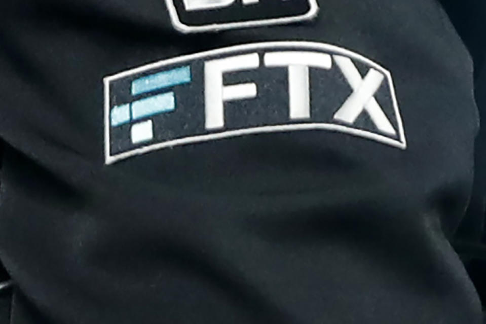 File - The FTX logo appears on home plate umpire Jansen Visconti's jacket at a baseball game with the Minnesota Twins on Tuesday, Sept. 27, 2022, in Minneapolis. On Friday, Nov. 18, The Associated Press reported on stories circulating online incorrectly claiming U.S. aid to Ukraine was laundered back to the Democratic Party through the failed cryptocurrency exchange firm FTX. (AP Photo/Bruce Kluckhohn, File)
