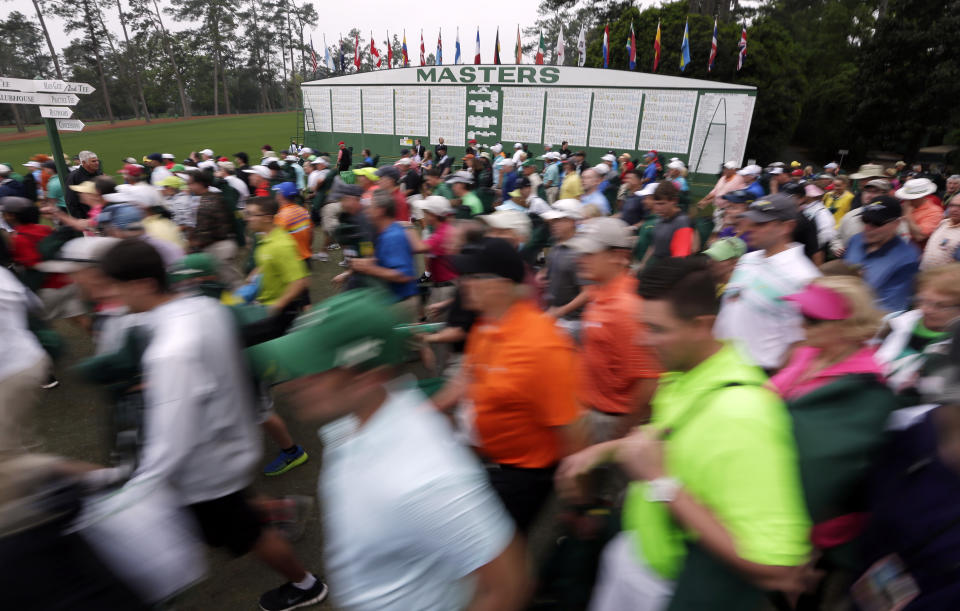 Spectators make their way to the course before the final round of the Masters golf tournament Sunday, April 12, 2015, in Augusta, Ga. (AP Photo/Charlie Riedel)