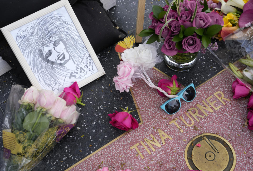 A portrait of the late singer Tina Turner sits next to flowers at her star on the Hollywood Walk of Fame, Wednesday, May 24, 2023, in Los Angeles. Turner died Tuesday at 83 after a long illness. (AP Photo/Chris Pizzello)