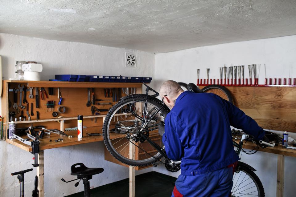 BASTOY ISLAND, HORTEN, NORWAY - APRIL 11:  Eroll, 51-years-old sentenced to two years and eight months for narcotic related crimes repairs a bycicle in Bastoy Prison on April 11, 2011 in Bastoy Island, Horten, Norway. Bastoy Prison is a minimum security prison located on Bastoy Island, Norway, about 75 kilometers (46 mi) south of Oslo. The facility is located on a 2.6 square kilometer (1 sq mi) island and hosts 115 inmates. Arne Kvernvik Nilsen, governor of the prison, leads a staff of about 70 prison employees. Of this staff, only five employees remain on the island overnight.  Once a prison colony for young boys, the facility now is trying to become 'the first eco-human prison in the world.' Inmates are housed in wooden cottages and work the prison farm. During their free time, inmates have access to horseback riding, fishing, tennis, and cross-country skiing. (Photo by Marco Di Lauro/Reportage by Getty Images)