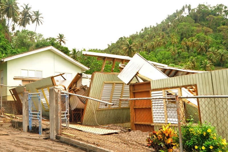 Debris is spread around a house following the passing of Hurricane Elsa